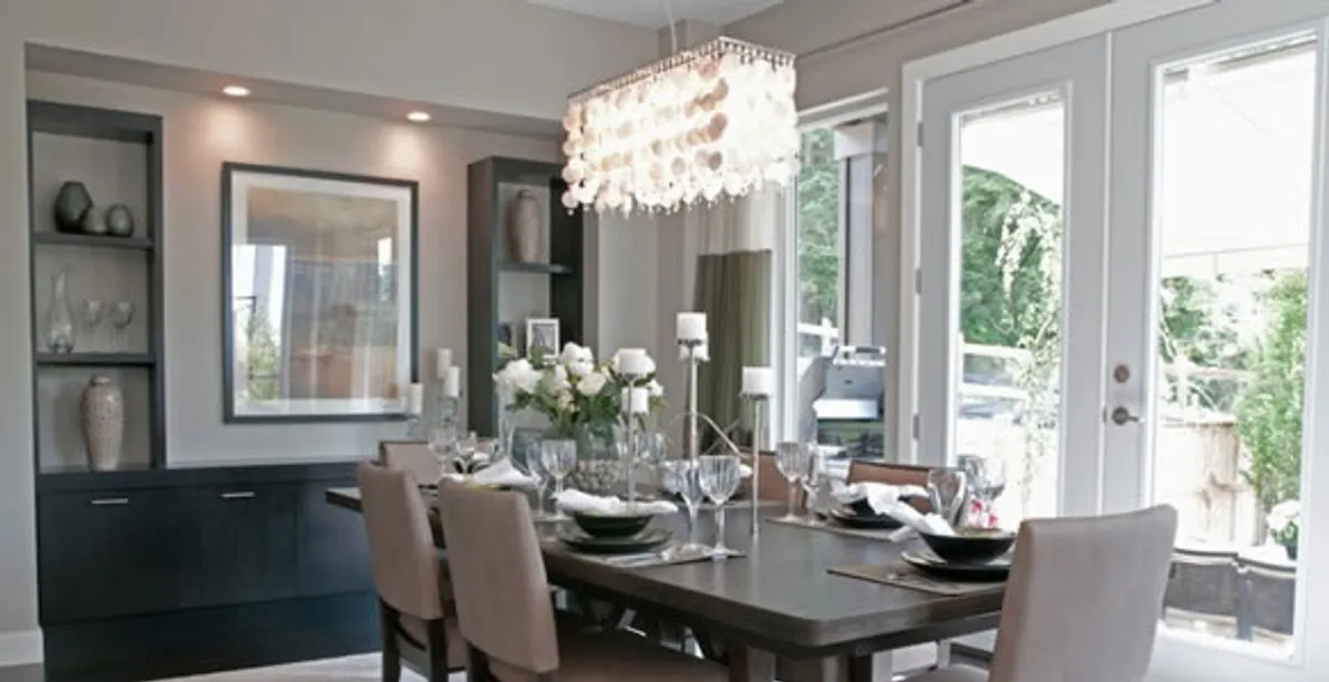 Elegant dining room chandelier installation above table in Columbia, MO